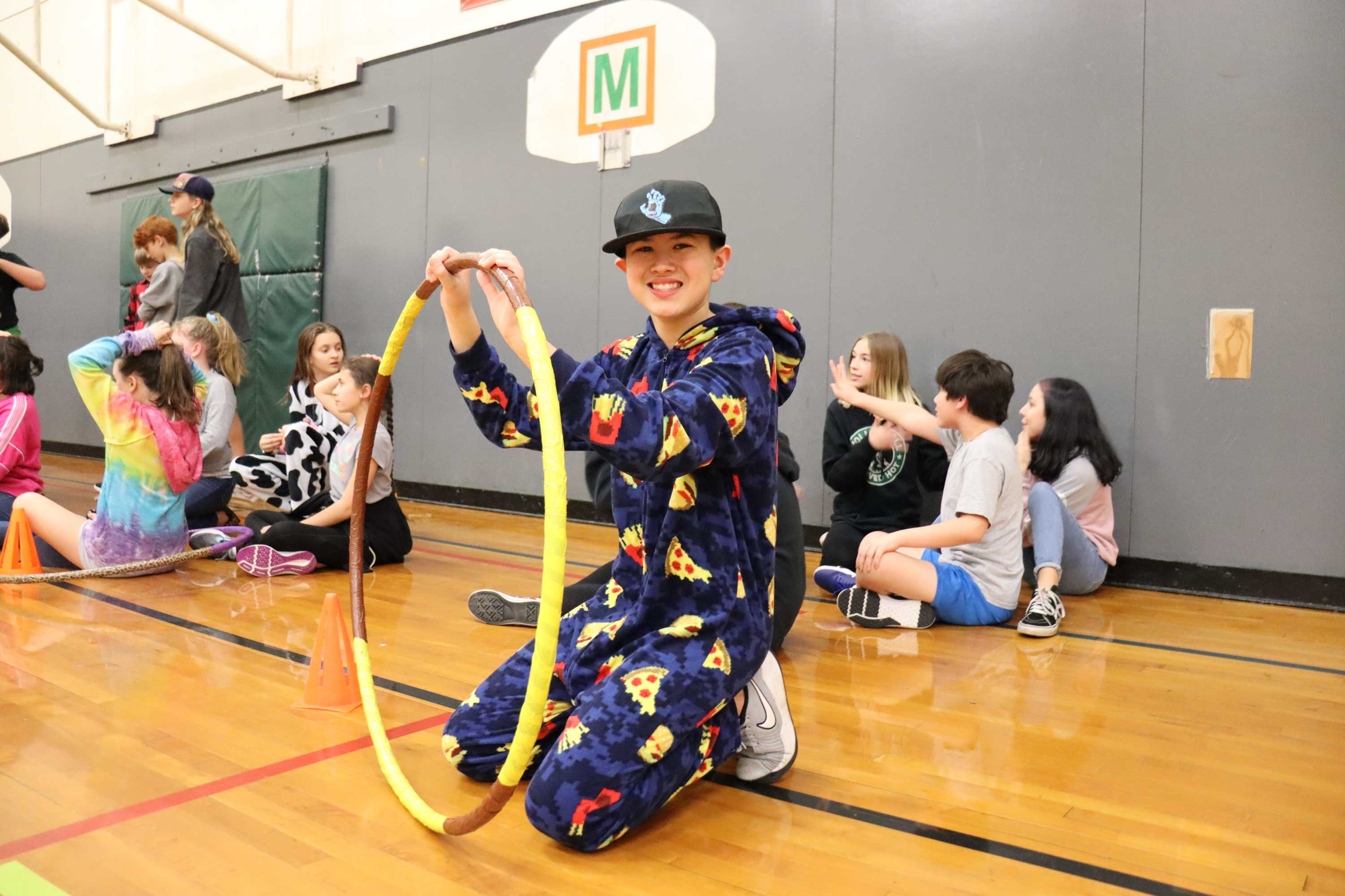 youth with hula hoop in the eugene ymca gym during middle school madness