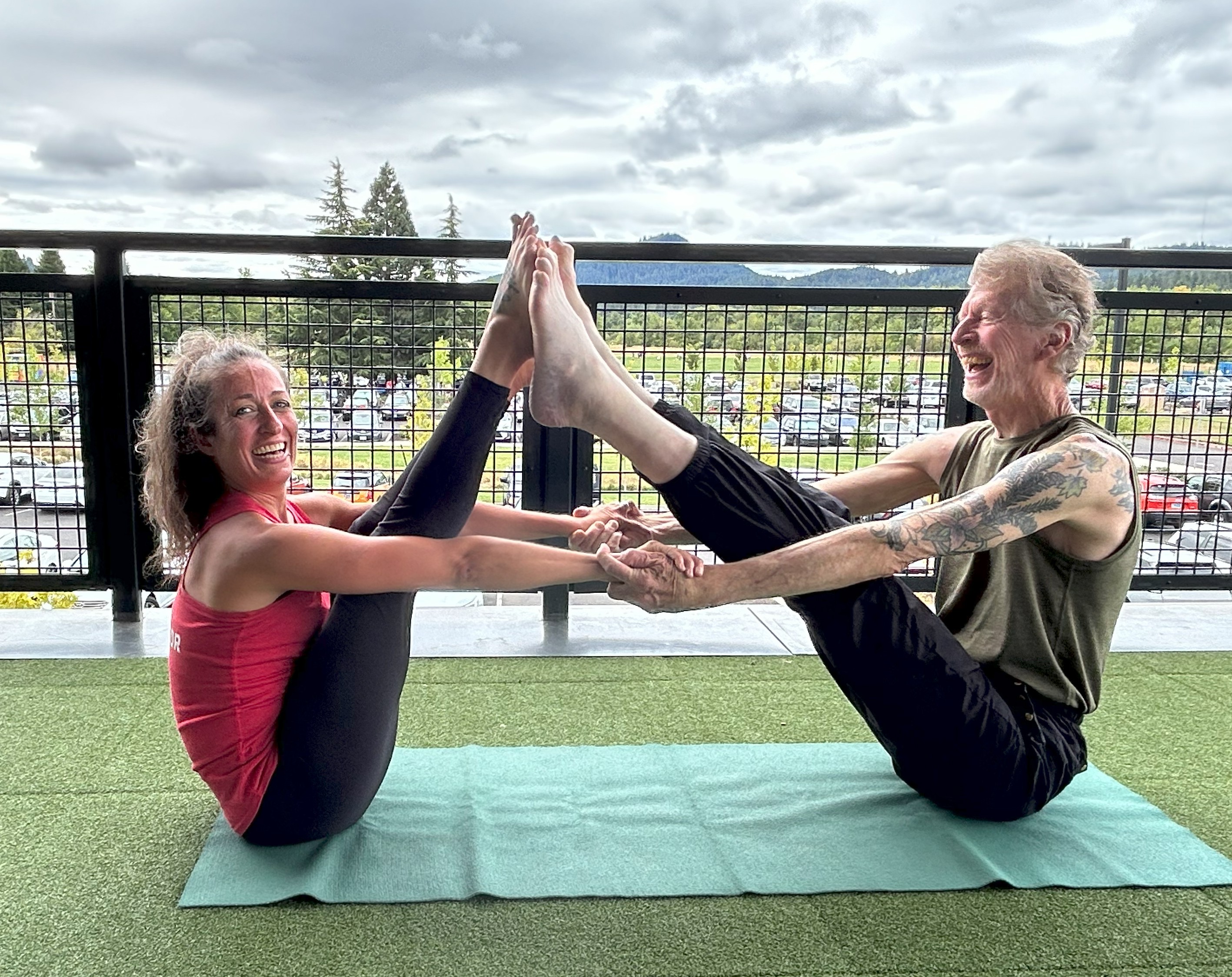 Partner yoga on the Eugene Family YMCA terrace
