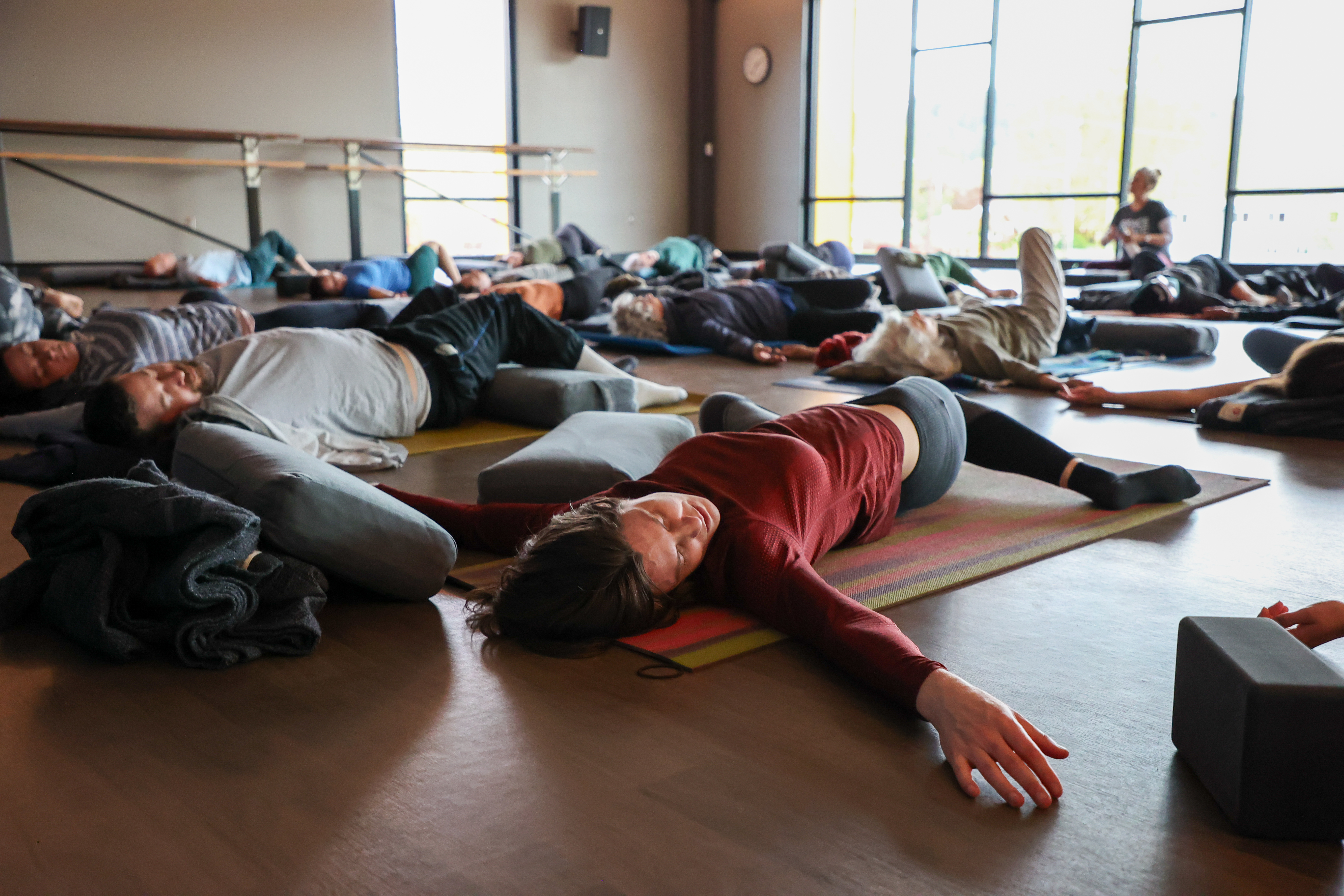 people doing spinal twists on yoga mats