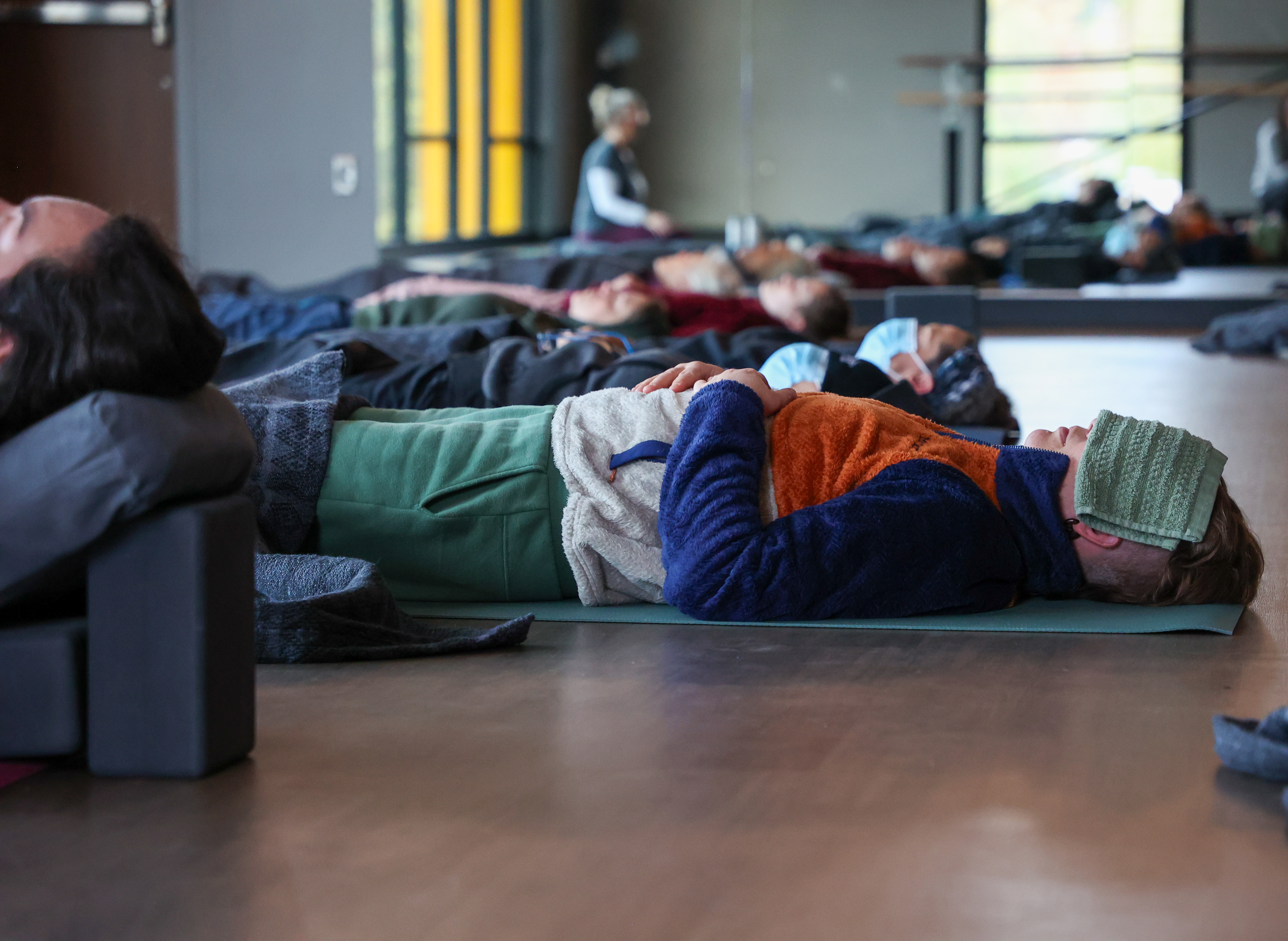 People relaxing during a yoga nidra class at the Y