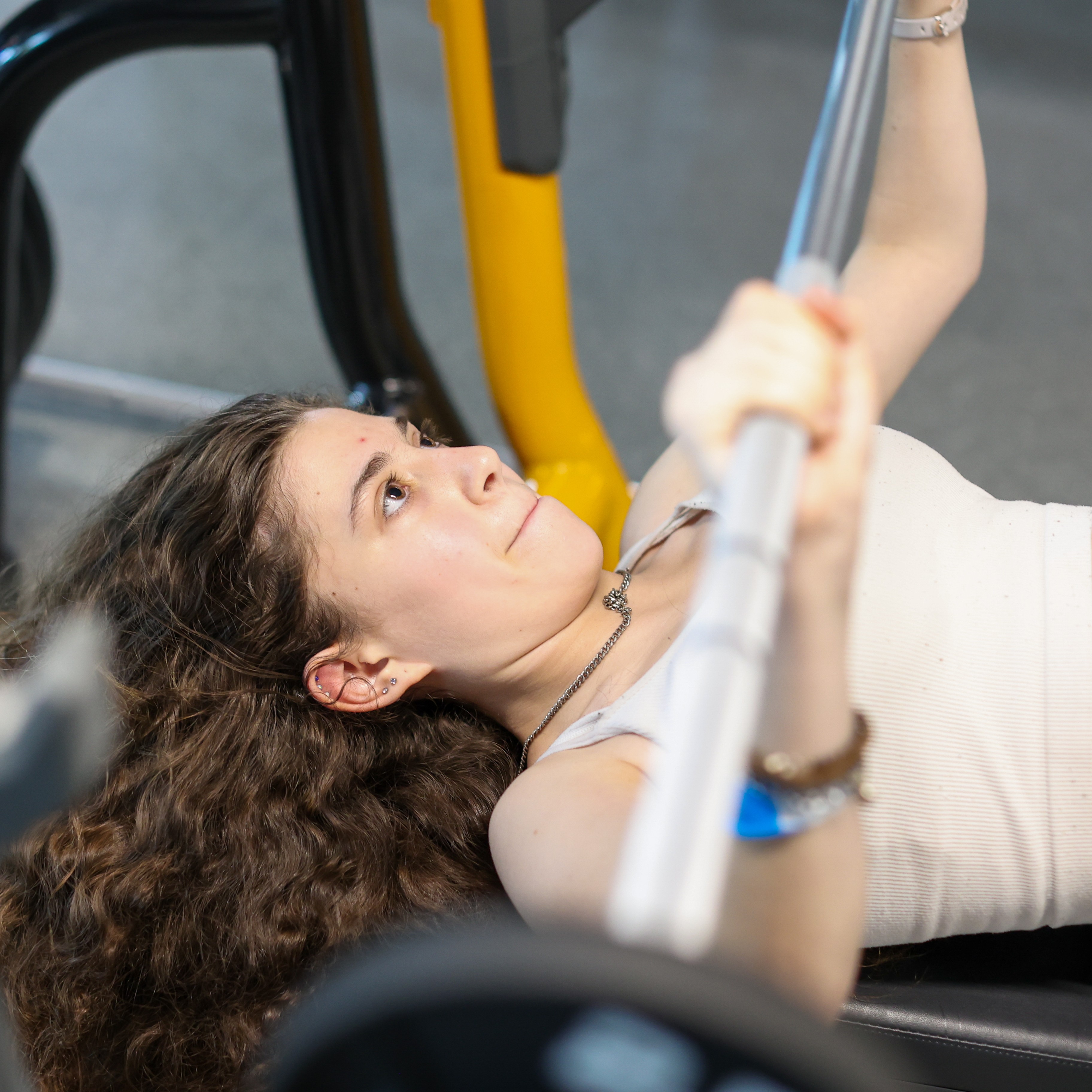 teen girl bench pressing at the Y