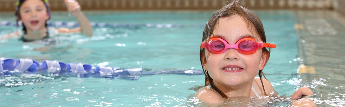 young girl swimming in ymca pool
