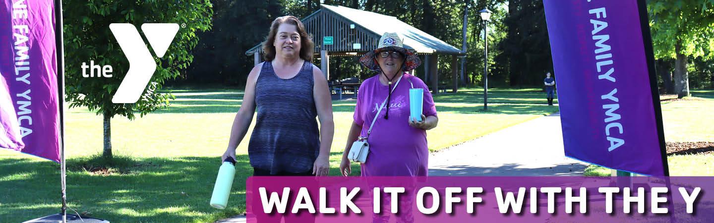 two women walk through alton baker park during walk it off with the y