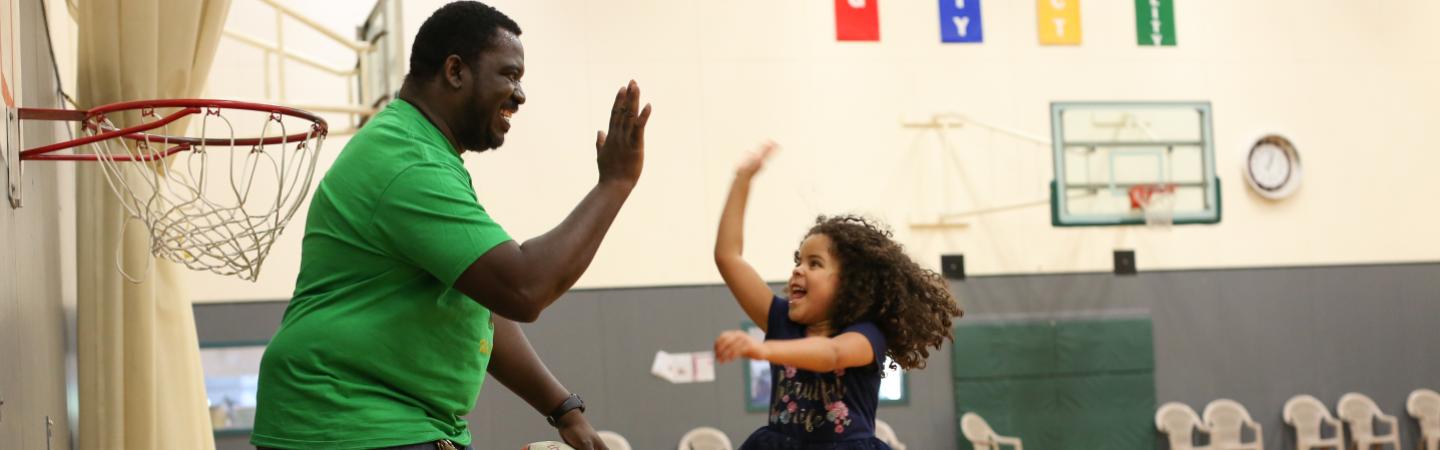 eugene ymca member high fives his daughter in the gym