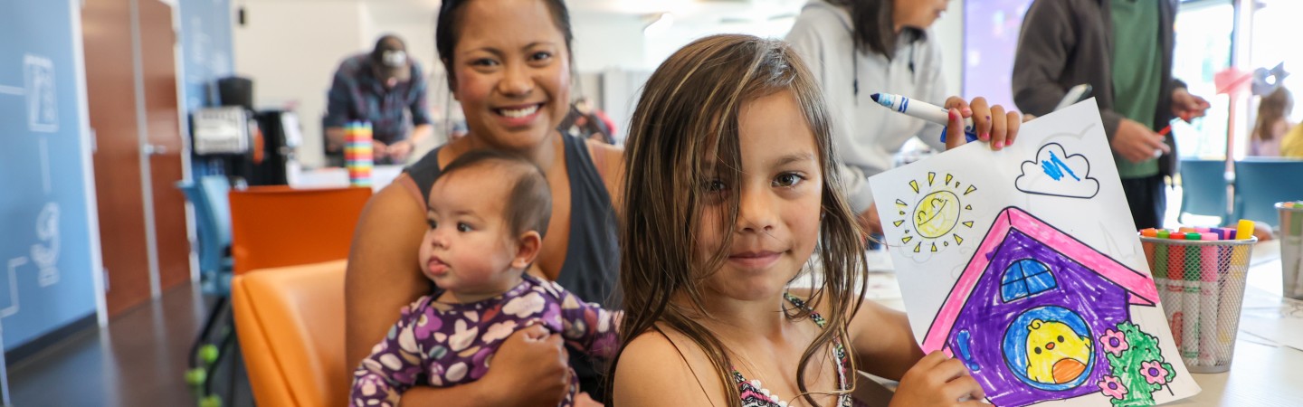 A mother and her two young kids enjoy Healthy Kids Day art projects at the Eugene Family YMCA