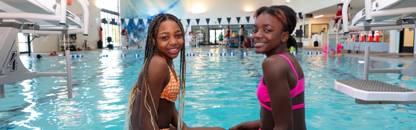 two girls swim in the ymca pool
