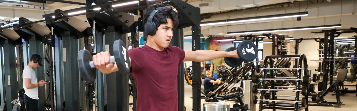 teen lifts weights in the ymca gym