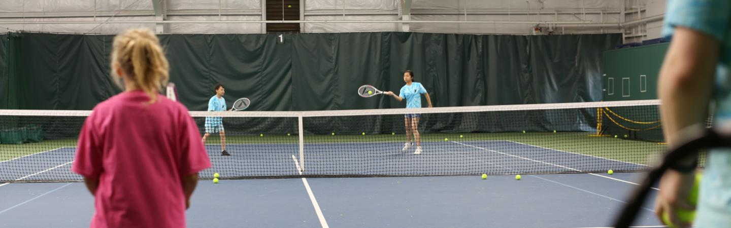 Youth playing tennis at the YMCA tennis center 