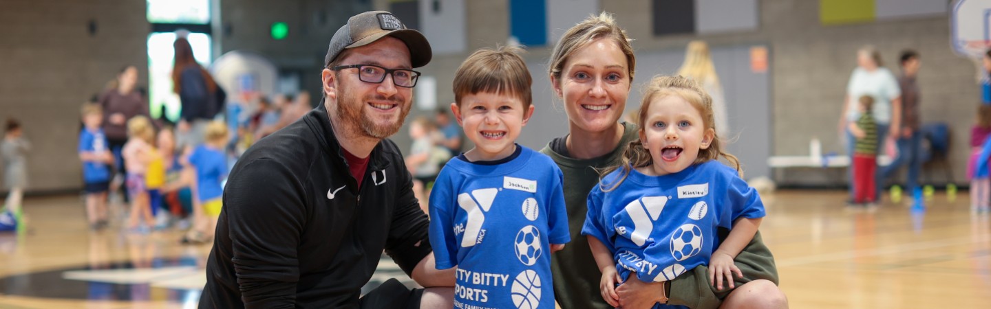 young family plays in gym during itty bitty track at ymca
