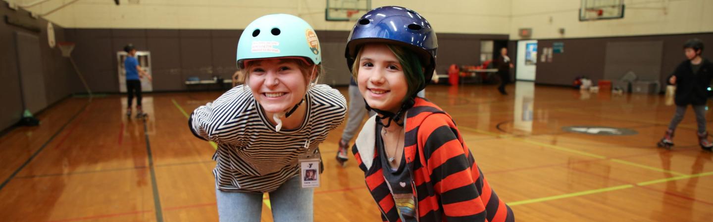 ymca staff and youth play basketball and roller blade in the ymca gym