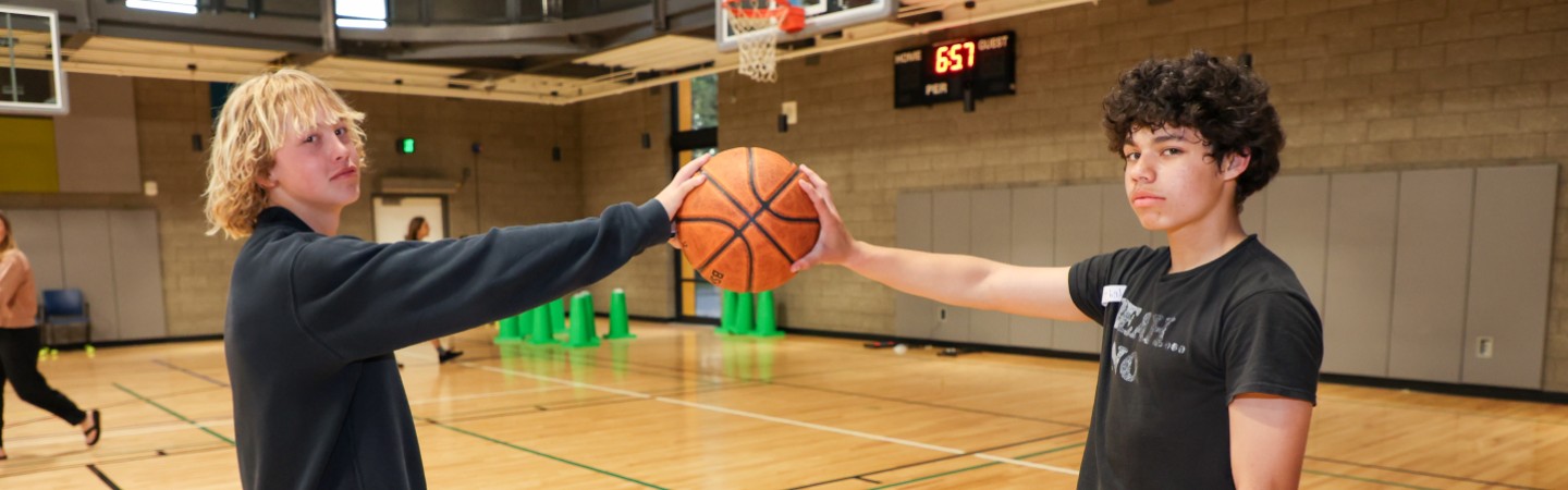 teenagers playing basketball in ymca gym