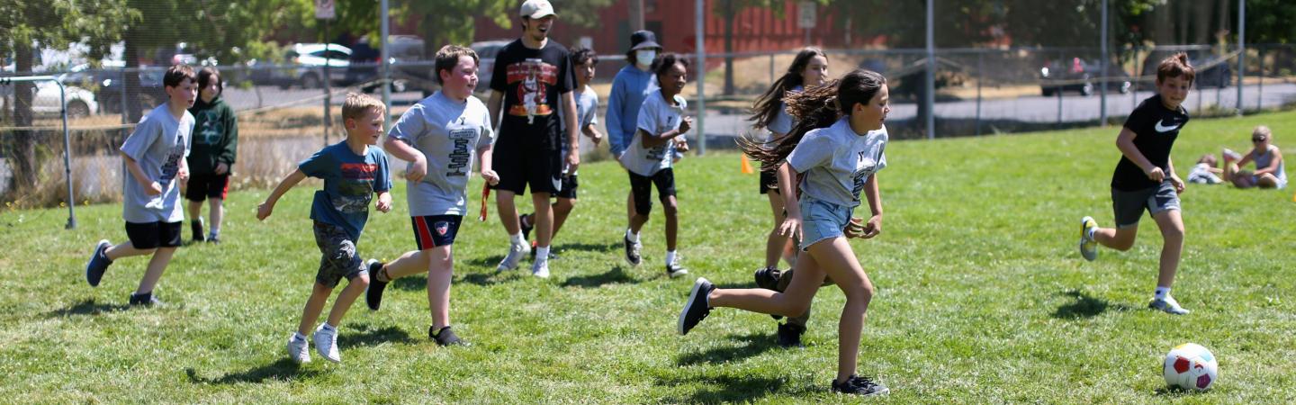 kids play soccer games at ymca summer sports camp