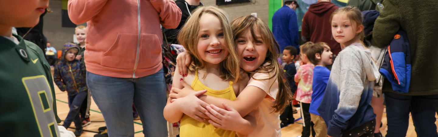 girls hug at healthy kids day event