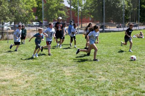 kids play soccer games at ymca summer sports camp