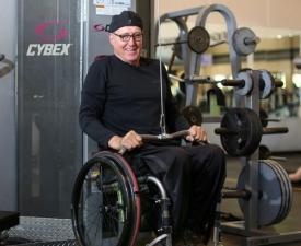 larry using weight machine in wheelchair