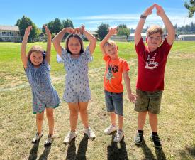 kids pose as YMCA during eugene ymca summer camp