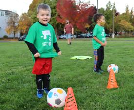 boy plays itty bitty soccer at ymca clinic