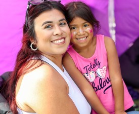 a mom and daughter smile at the camera at the Y's welcoming festival