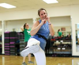 ymca member demonstrates a martial arts kick