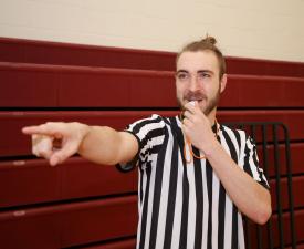 basketball ref blows whistle during game