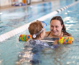 Instructor with child in swim lesson