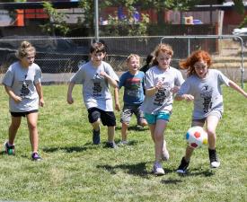 summer campers play soccer at eugene ymca sports camp