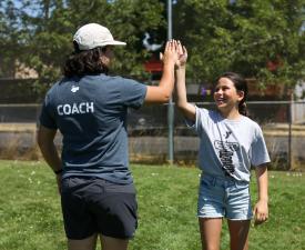 girl high fives her coach at eugene ymca sports camp