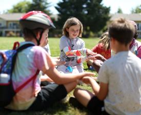 girl plays patty cake in a cirlce at ymca summer camp