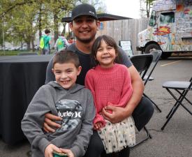 dad with kids smiles at eugene ymca health kids day event