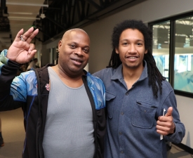 two men smile in the ymca gym