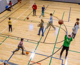 families shoot hoops during open gym