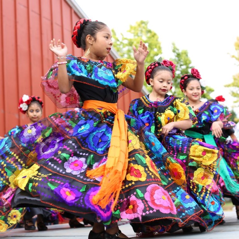 young girls perform mexican traditional dance at eugene ymca welcoming festival